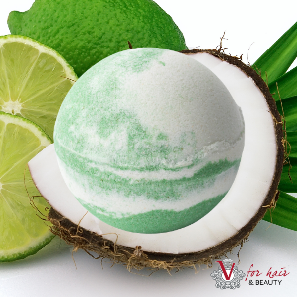Tilley - Coconut & Lime Luxurious Bath Bomb in front of coconuts and limes