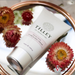 Tilley - Peony Rose Hand & Nail Cream - 45ml flatlay on mirror with flowers