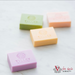 Assorted Colourful Tilley soaps scattered