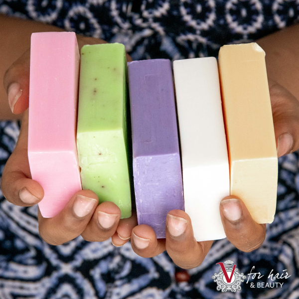 assorted coloured Tilley soaps arranged in hand